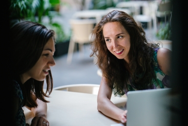 two-talking-women-while-using-laptop-1311547-b1ee8c43b2fd1899c8ee51546e8d9d19.jpg